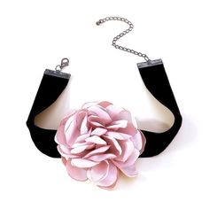 a pink flower is attached to a black choker