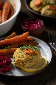 a plate topped with food next to carrots and cranberry sauce