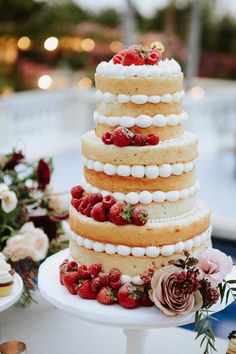 a wedding cake with strawberries and marshmallows on top