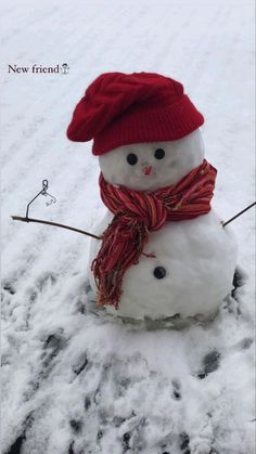 a snowman wearing a red hat and scarf