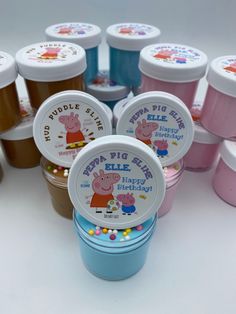 many plastic containers filled with jelly beans and pep pig's birthday cake toppings