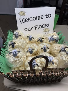 a basket full of popcorn with sheep on it and a welcome to our flock sign