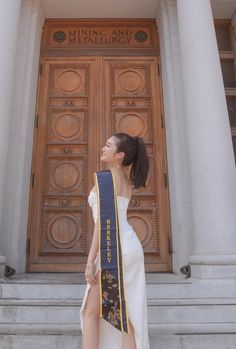 a woman standing in front of a large door