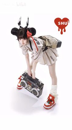 a doll is standing on top of a box with her hands in the air and wearing red shoes