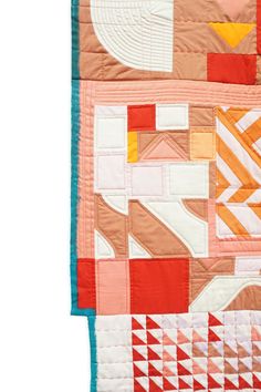 an orange and white quilted wall hanging