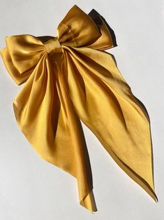 *Trending* Style notes - satin bow - hand-knotted bow - french barrette clip Dimensions Bow - 16" length; 9" width Barrette - 3.5" Yellow Hair Bow, Satin Hair Bow, Plunge Maxi Dress, Yellow Hair, French Barrette, Silk Hair, Bow Hair Clips, Bow Clips, Romper With Skirt