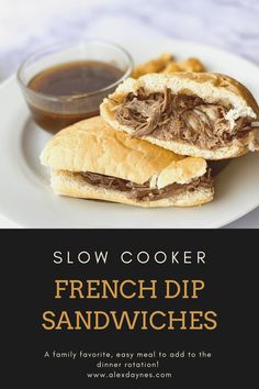 slow cooker french dip sandwiches on a white plate with dipping sauce in the background