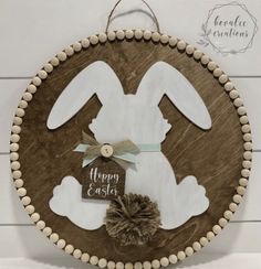 a wooden sign that says happy easter with an image of a bunny in the center