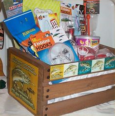 a wooden box filled with assorted items on top of a bed