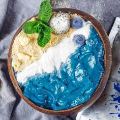 a bowl filled with blue and white dessert