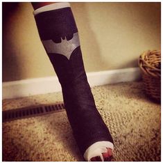 a person's leg with a batman bandage on it