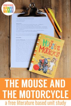 the mouse and the motorcycle book is next to a clipboard with pencils on it