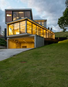 a modern house on top of a grassy hill