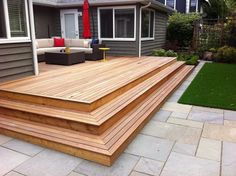 a large wooden deck in front of a house