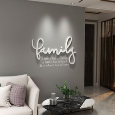 a living room filled with furniture and a wall mounted sign that says family on it