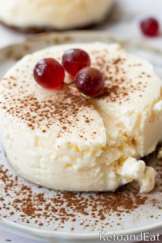 two desserts on a white plate topped with whipped cream and cherries