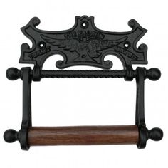 an old fashioned black iron towel rack with wooden handles