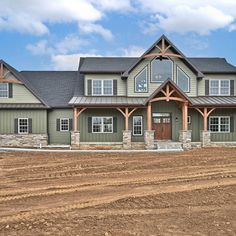 a large green house sitting on top of a dirt field