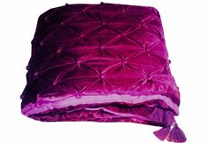 a purple blanket with tassels on it