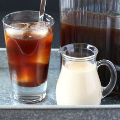 two pitchers of iced coffee and a pitcher of liquid