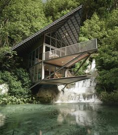 a house built into the side of a waterfall