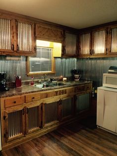 a kitchen with wooden cabinets and white appliances