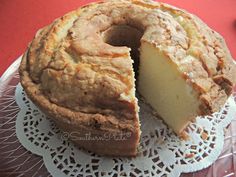 a cake that has been cut in half on a doily with a piece missing