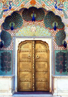 an ornate door with peacocks painted on it