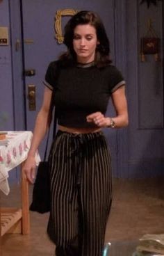 a woman in black shirt and striped pants