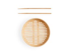 a wooden plate with chopsticks and a bamboo strainer on the side, set against a white background