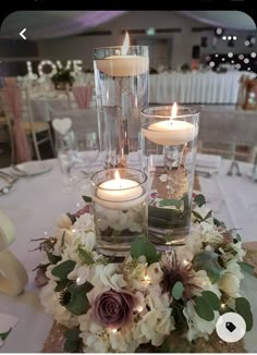 candles are lit on top of the centerpieces