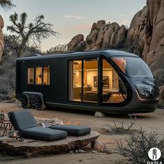 a tiny house in the middle of desert with an outdoor lounge chair and table next to it