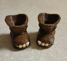 a close up of a pair of brown shoes with white teeth on the inside of them