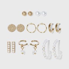 Mix things up a bit with the varied styles in this Faux Pearl Hoop, Ear Cuffs and Stud Earring Set from A New Day™. This set includes two pairs of textured hoop earrings, faux-pearl stud and hoop earrings, disc earrings, bar studs and faux-pearl dangle ear cuffs, all in a high-polish yellow gold-tone finish for a bright look. Each pair of stud earrings and small hoop earrings are set on post hardware with butterfly backs for comfortable, secure wear, while the ear cuffs simply sit on the ear wit Buy Pearls, Earring Sets, Winter Capsule, Winter Capsule Wardrobe, Bar Studs, Ear Cuff Earings, Disc Earrings, Hoop Earring Sets, Ear Stud