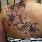 a woman with a flower tattoo on her back