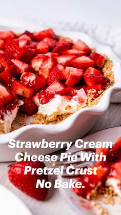 there is a pie with strawberries on it and a fork next to the pie