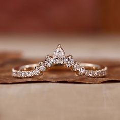 a diamond ring sitting on top of a piece of wood