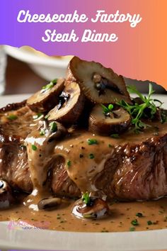 the steak is covered with mushrooms and gravy on the plate in front of it