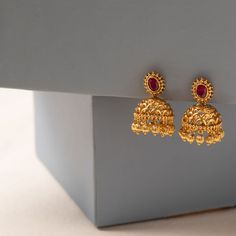 Description: These simple Jhumki earrings are stunning yet traditional. Deeply rooted in India's culture; these filigree patterned earrings are handcrafted with CZ stones along with fine antique gold plating. These earrings are a perfect match for your next special event! Details & Specifications: Materials used: CZ stones and Antique Plated brass. Weight - Earrings: 13.24 gms Length - Earrings: 3 cms Make it custom Want to make it a custom earrings? Sure! Reach out to us at support@tarinika.com Gold Earrings Party Wear, 3 Gms Gold Earrings, Gold Jhumki New Design, Small Jumkas For Daily Use, Jhumki Designs Gold Indian Bridal, Jumkis Indian Jewelry Gold, Gold Bridal Earrings Indian, Simple Gold Earrings Indian, Antique Gold Earrings Simple