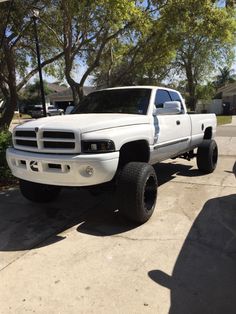 a white pickup truck parked in a driveway