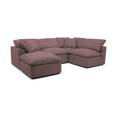 a large sectional couch with pillows on the top and bottom corner, facing away from the camera