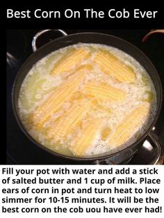 a frying pan filled with corn on the cob next to a red apple