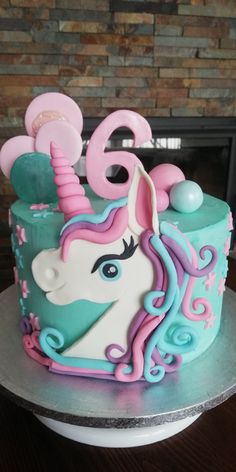 a birthday cake decorated to look like a unicorn