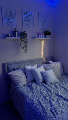 a bed with white pillows and blue lights