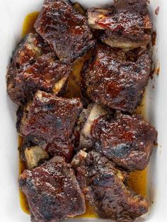 oven baked bbq beef short ribs in a casserole dish with text overlay