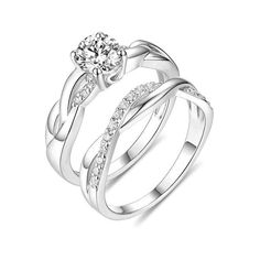 two white gold wedding rings with diamonds on each band and the center diamond in the middle