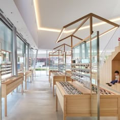 the inside of a store with lots of wooden shelves and glass doors on both sides