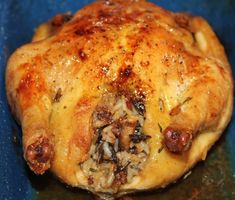 a close up of a cooked chicken on a blue plate