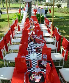 a long table set up with red and white chairs