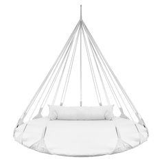 a white swing chair with pillows on it's back and the seat in front